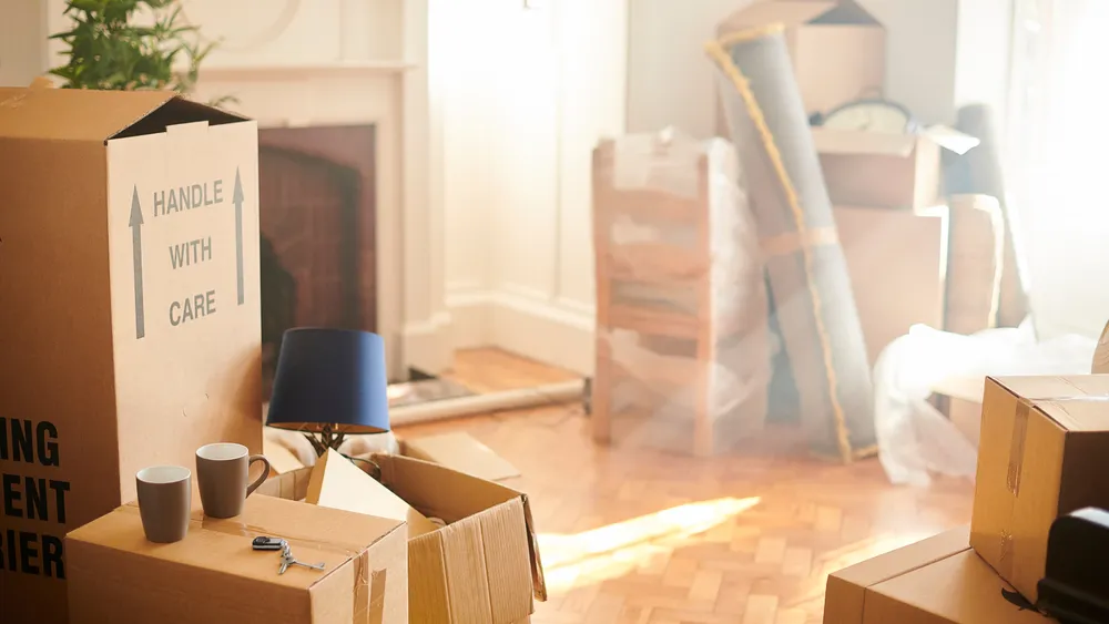 Boxes and belongings in a room, indicating a move.